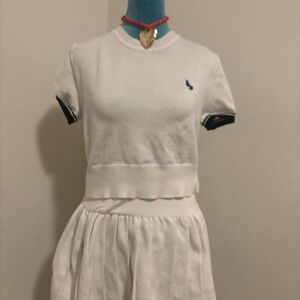 White‎ polo shirt with navy blue stripes and embroidered logo